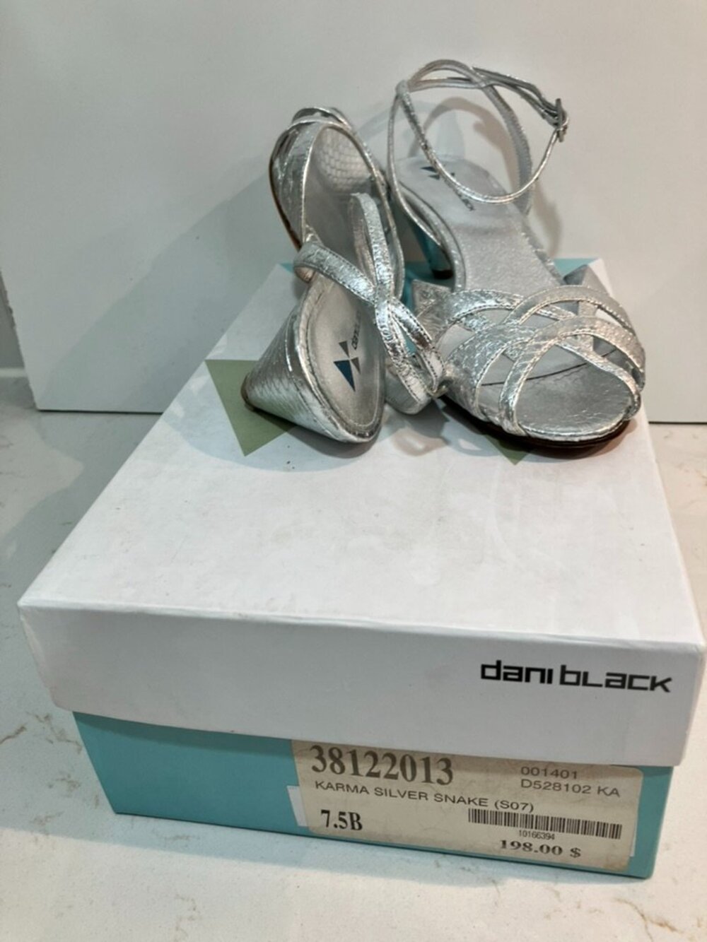 Gorgeous Dani Black Karma sandals in a chic silver snake print leather.